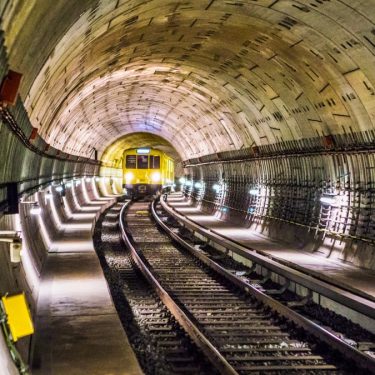 Dramatic view of a Berlin subway tunnel with train approaching, showcasing modern infrastructure.