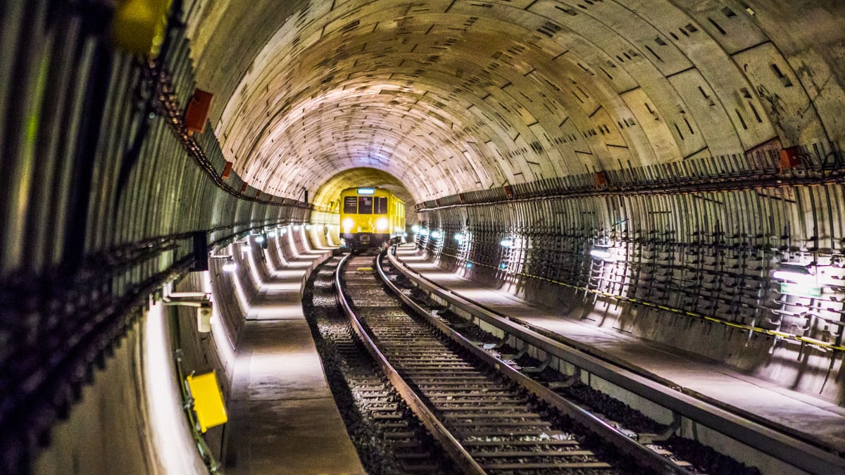 Dramatic view of a Berlin subway tunnel with train approaching, showcasing modern infrastructure.